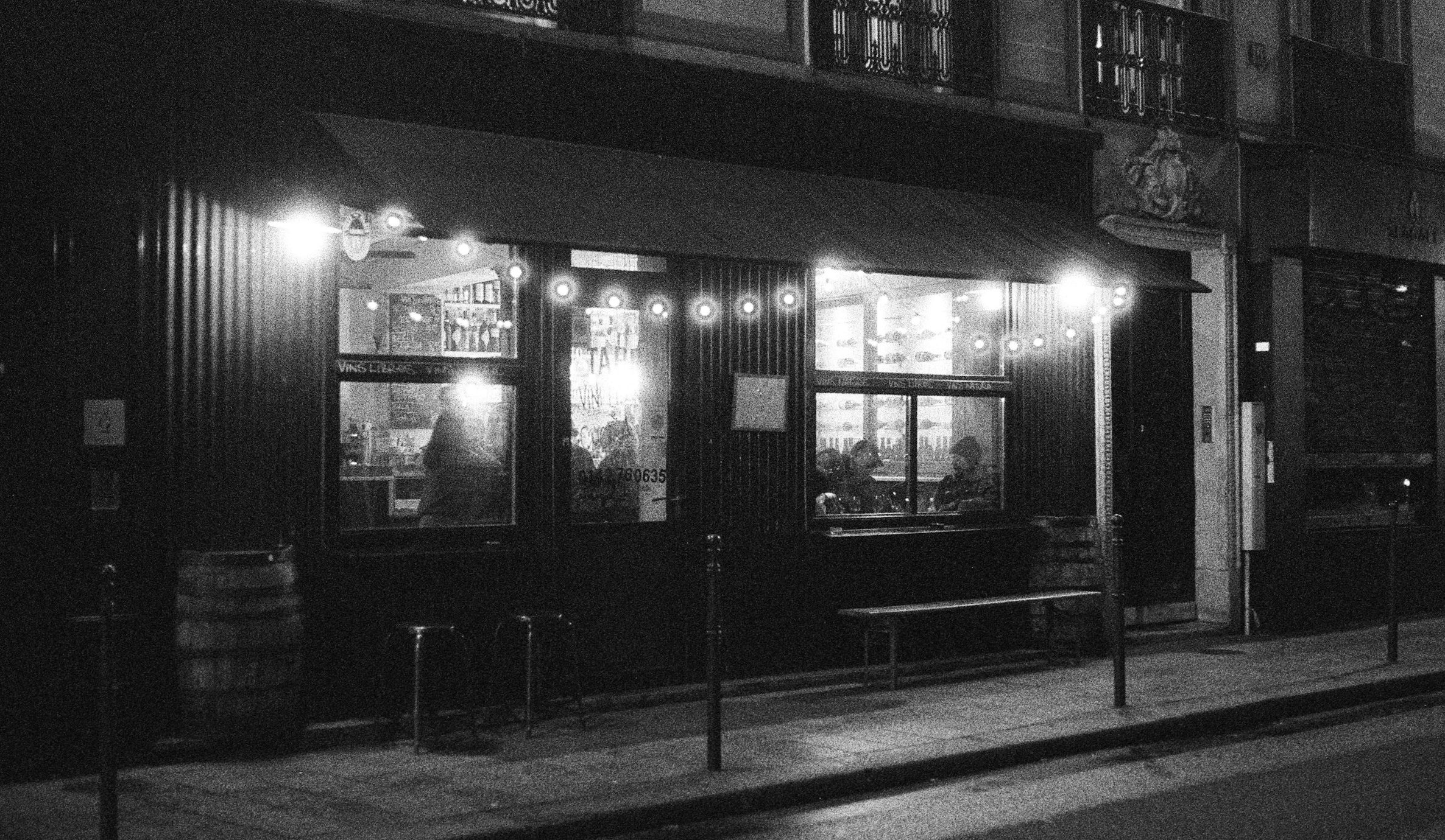 Dimly lit storefront with string lights at night
